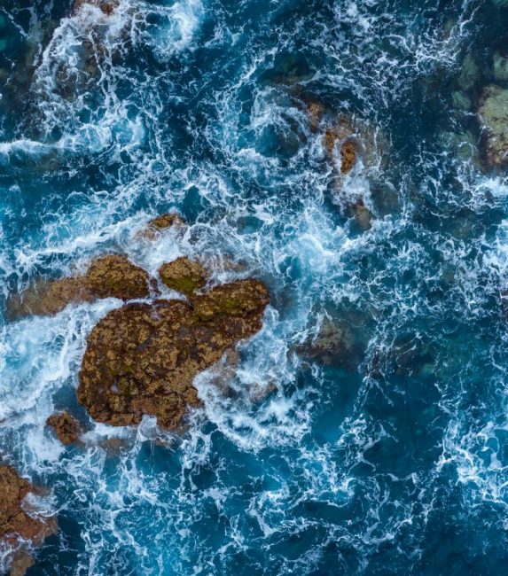 Top view of a deserted coast. Rocky shore of the island of Tenerife, Canary Islands, Spain. Aerial drone photo of ocean waves reaching shore